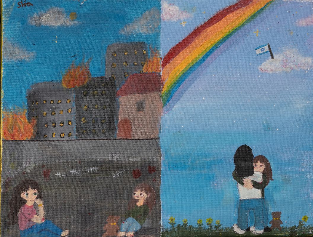 Acrylic painting on canvas. The painting is divided into two parts: on the right, mother and daughter are embracing, the mother with her back to us and the daughter is embracing her and her head is peeking over the mother’s shoulders. Next to them are brown toy bears. They stand small among yellow flowers. The background is a bright blue sky with a large rainbow of many colors and white clouds, on one of which is the Israeli flag. The second part of the painting, divided into two parts by lines. Above, gray buildings and a house with a red roof against a blue sky. On top of the houses, surrounded by flames of fire, and below a black line, the mother and the child with the teddy bear, sitting in a dark, dark gray tunnel, each on a different side, their faces sad and frightened, above them a line mark that is a map of despair. The teddy bear at the girl’s feet.