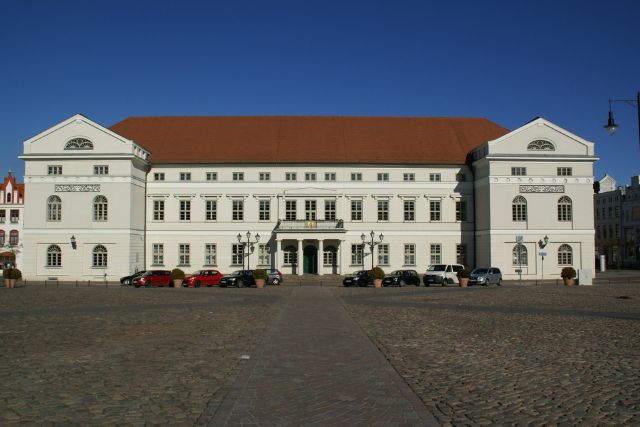 View of the town hall building and the forecourt of the city of Wismar with blue sky and sunshine