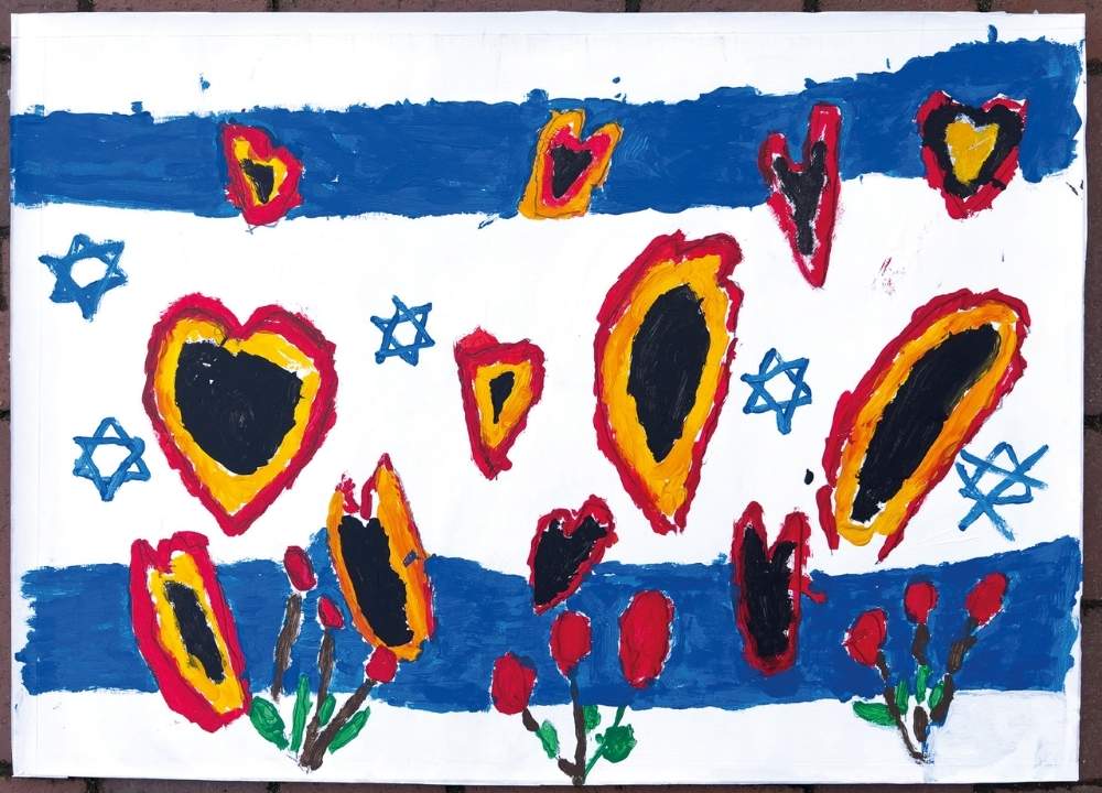 The background of the painting is the Israeli flag in blue and white. Several hearts are drawn in red, yellow, and black. In the foreground, flowers are painted in red and green.