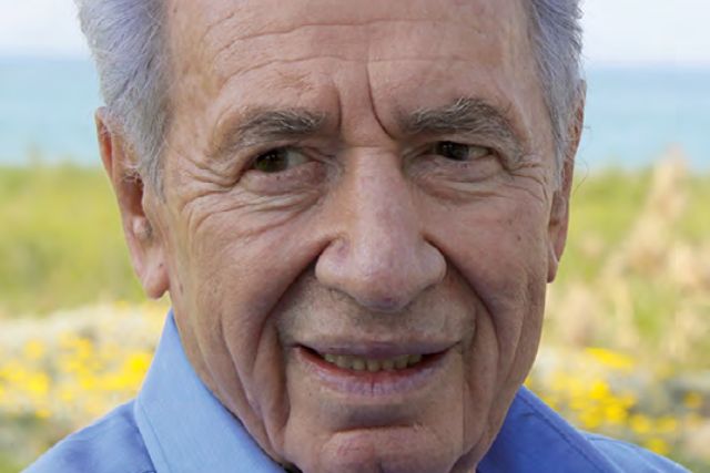 Close-up of an older man with grey hair and a blue shirt